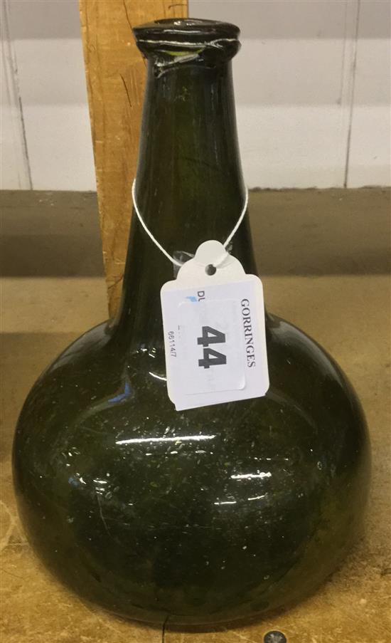 A Dutch green glass onion shaped wine bottle, early 18th century, 20cm.